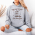 Celebrate the beauty of quirky connections with our comfy hoodie, featuring an adorable illustration of a raccoon and possum sharing a heartwarming hug.